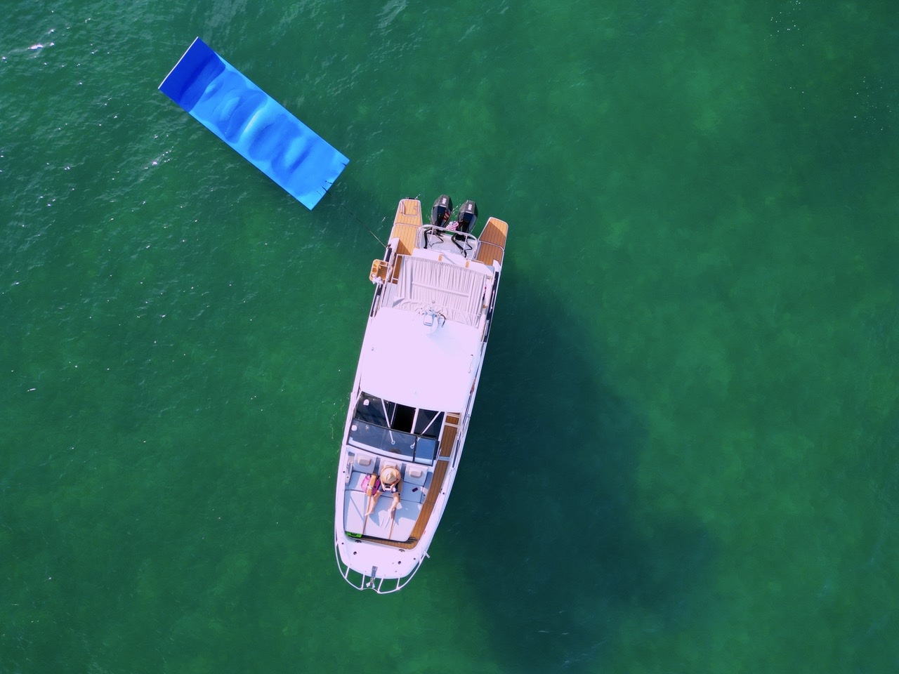 Aerial drone shot of private yacht charter with floating mat deployed near Fort Lauderdale sandbar