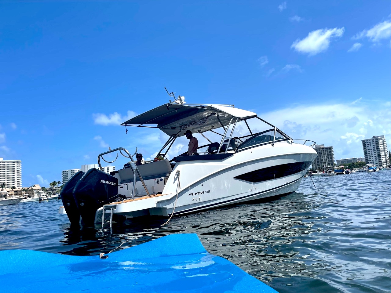 Beneteau Flyer 32 anchored with floating mat deployed on Fort Lauderdale waterway